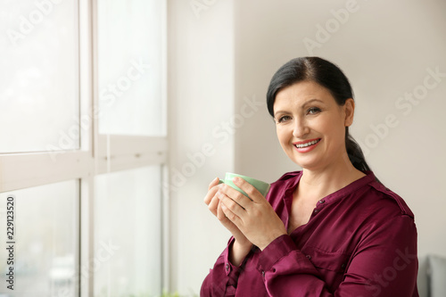 Beautiful mature woman drin...
