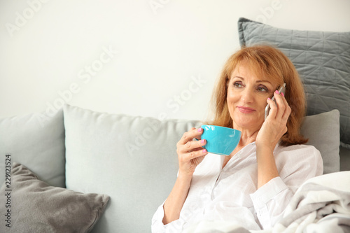 Beautiful mature woman drin...