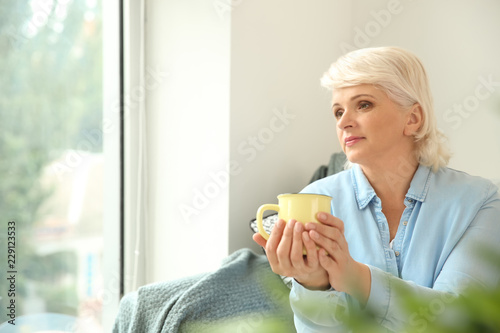 Beautiful mature woman drin...