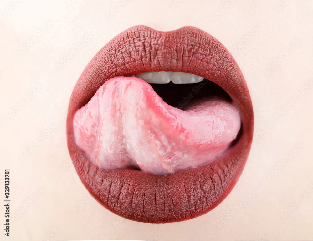 Tongue and sexy mouth. Woman lip, female lips. Beautiful lip, lipstick and  lipgloss, passionate, sensual makeup. Sexy lips, tongue out. Close up,  macro with beautiful mouth. Sensual girl. foto de Stock