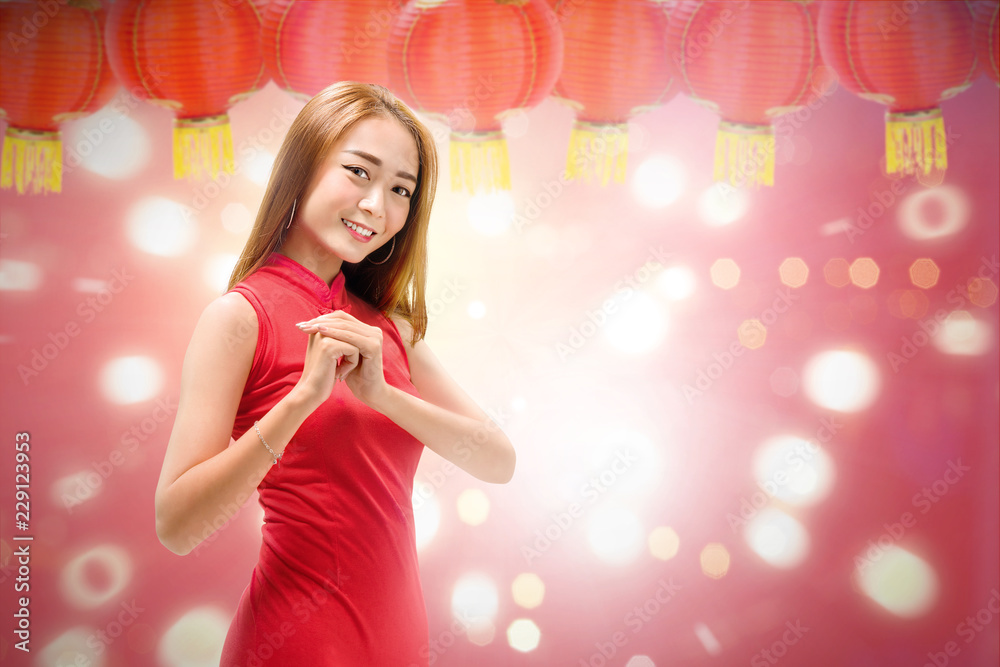 Beautiful chinese woman with cheongsam dress and congratulation gesture Beautiful chinese woman with cheongsam dress and congratulation gesture