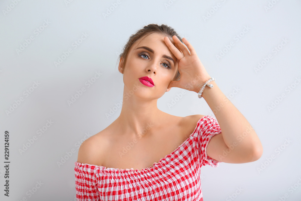 Beautiful young woman on light background Beautiful young woman on light background