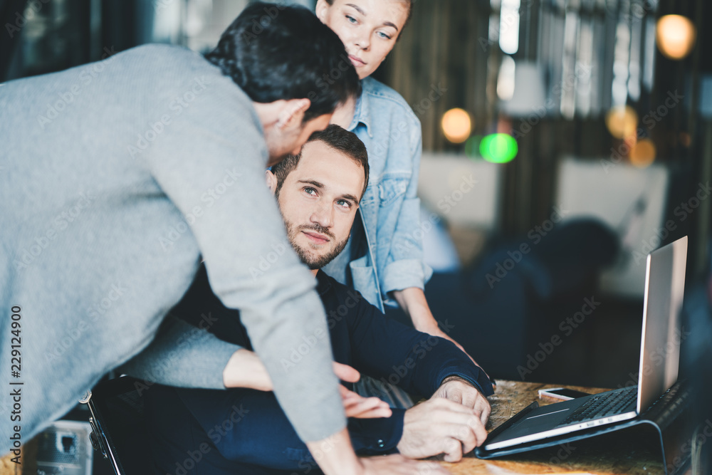 Fototapeta premium Startup and millenial business concept. Young manager team discussing new strategy