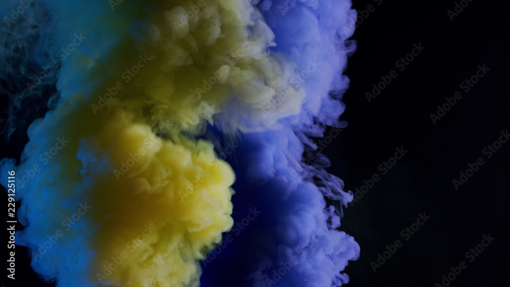 yellow and blue bomb smoke on black background