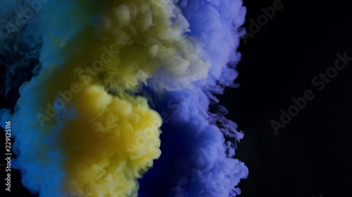 yellow and blue bomb smoke on black background