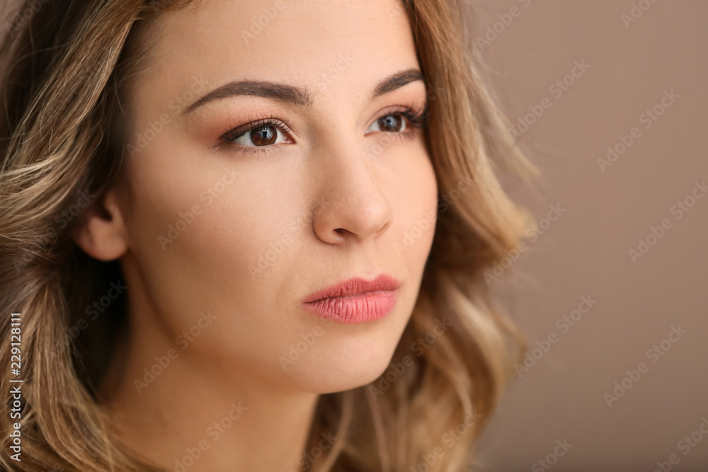 Portrait of beautiful young woman on color background, closeup