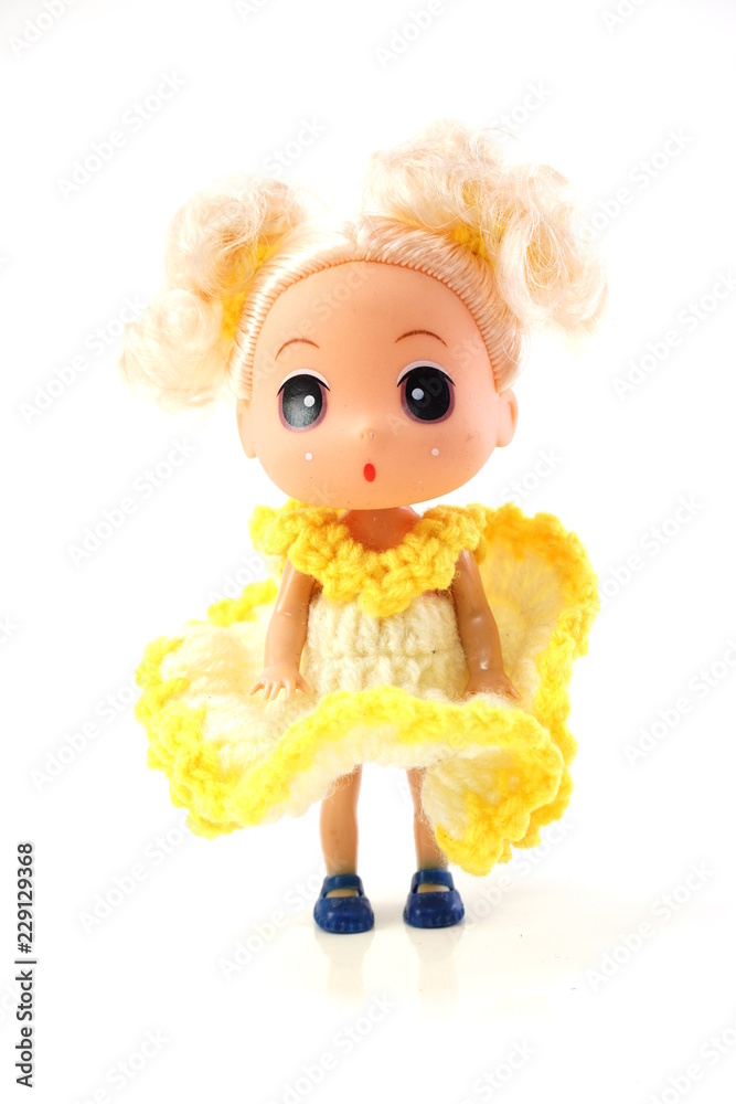 beautiful baby doll with yellow dress isolated on white background