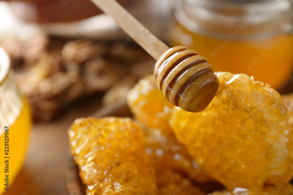 Wooden dipper and honeycomb, closeup Wooden dipper and honeycomb, closeup