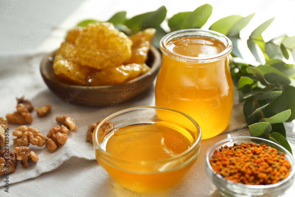 Bowl and jar with honey on table Bowl and jar with honey on table