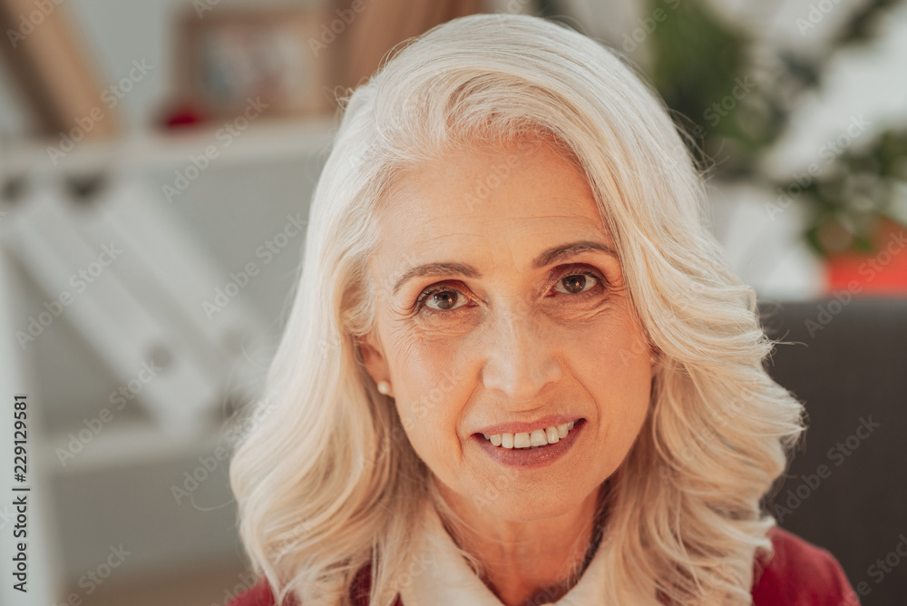Sincere smile. Close up of pleasant senior lady smiling sincerely and looking at you while having splendid mood Sincere smile. Close up of pleasant senior lady smiling sincerely and looking at you while having splendid mood