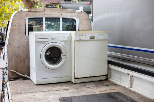 Old discarted dishwasher and washing machine on a vehicle  truck for recycling