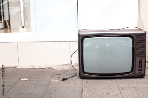 An old broken TV left on the street.
