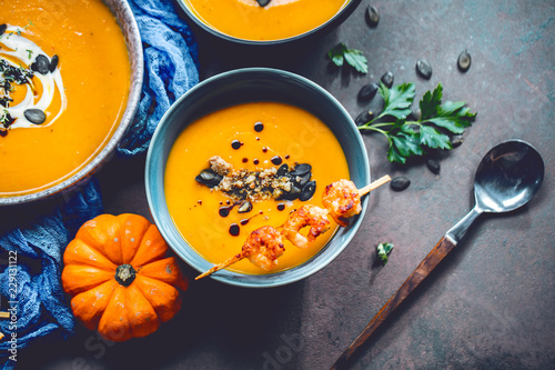 Roasted pumpkin and carrot soup with cream and pumpkin seeds  © karepa