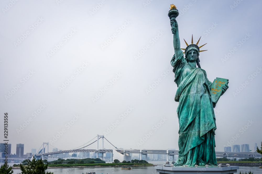Statue of liberty and tokyo cityscape, Japan