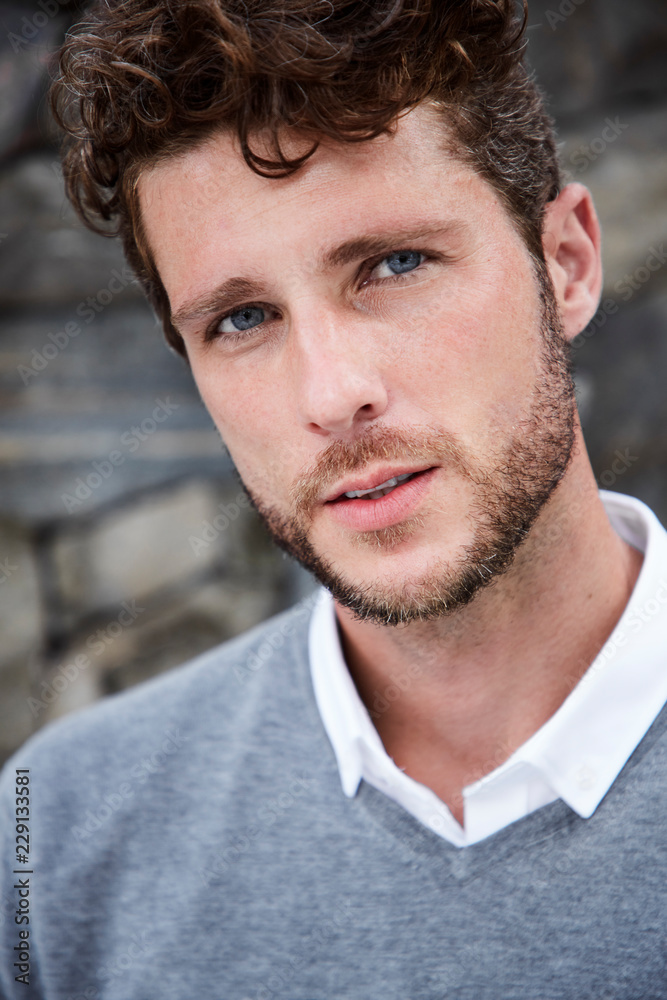 Fototapeta premium Handsome young guy in grey, portrait