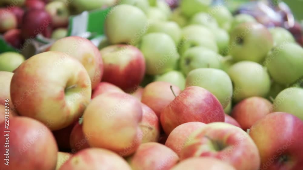 Showcase with apples in the store. The camera is slowly moving from one variety of apples to scold. First red, then green Showcase with apples in the store. The camera is slowly moving from one variety of apples to scold. First red, then green