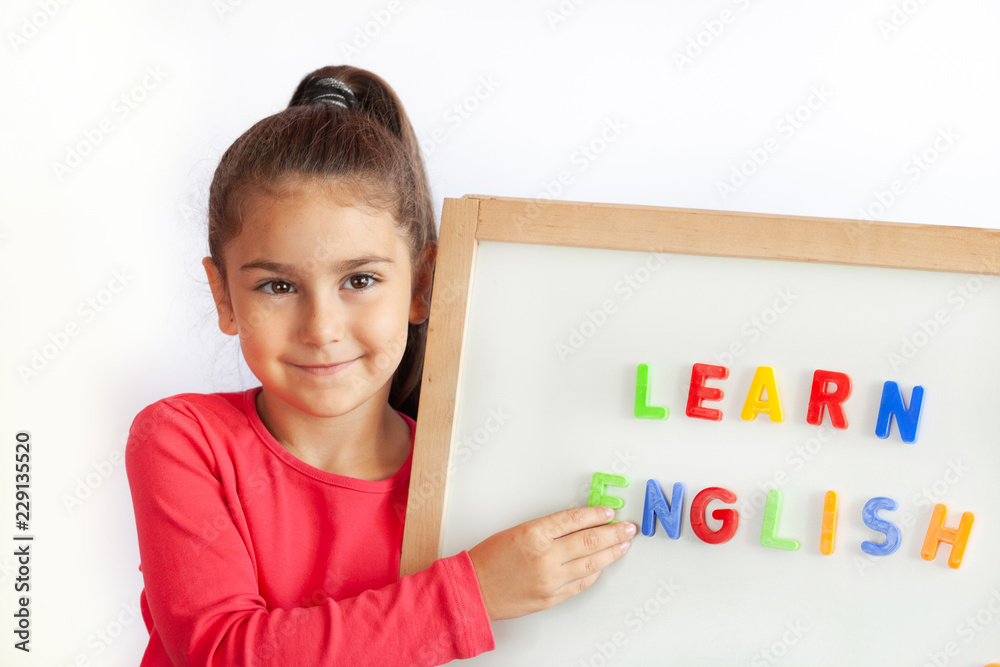 Language education concept. Learn English. Do you speak English. Cute little  child girl with colored letters on the blackboard. English language school.  English for children. Photos | Adobe Stock