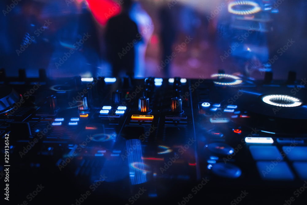 Fototapeta premium DJ mixer for mixing music and sound in a nightclub at a party