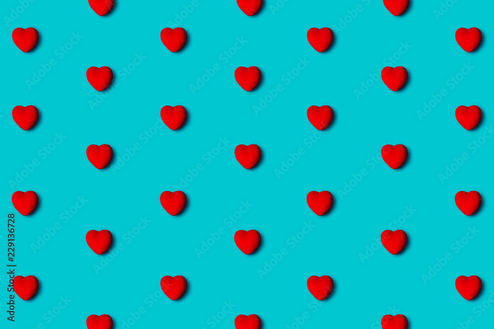 Red hearts pattern on a blue background, flat lay. Top view. Red hearts pattern on a blue background, flat lay. Top view.