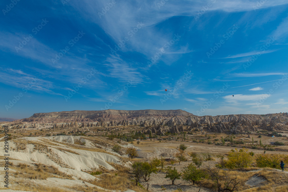 Beautiful Red valley in Cappadocia with cloudy sky in the background Beautiful Red valley in Cappadocia with cloudy sky in the background