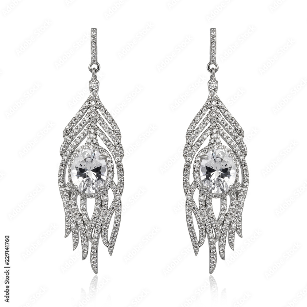 Pair of silver diamond earrings isolated on white Pair of silver diamond earrings isolated on white
