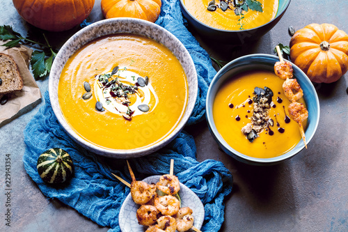 Roasted pumpkin and carrot soup with cream and pumpkin seeds 