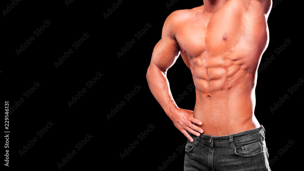 Fitness concept. Muscular and fit torso of young man having perfect abs, bicep and chest. Male hunk with athletic body on black background. Fitness concept. Muscular and fit torso of young man having perfect abs, bicep and chest. Male hunk with athletic body on black background.
