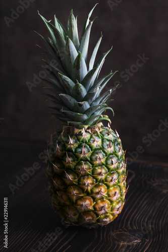 Ripe pineapple on a  wooden table