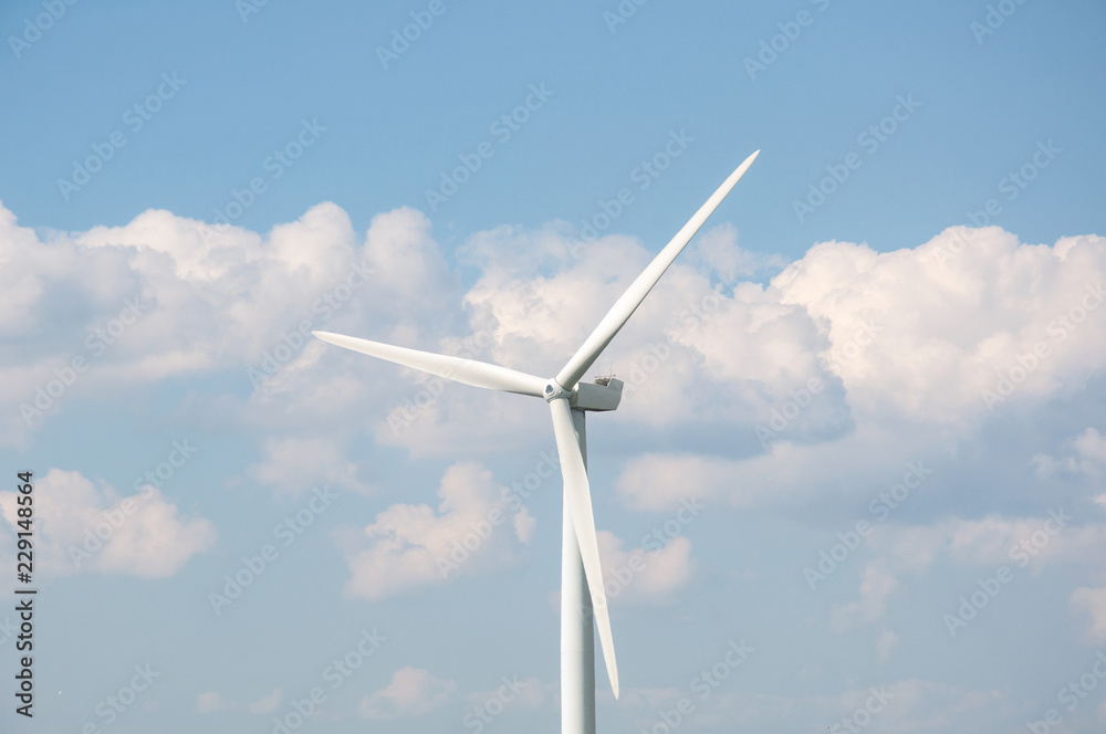 Wind turbine against blue sky and clouds background Wind turbine against blue sky and clouds background