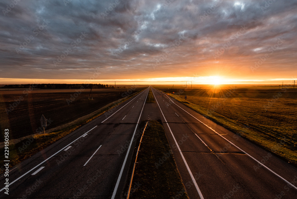 Two lanes highway at sunrise