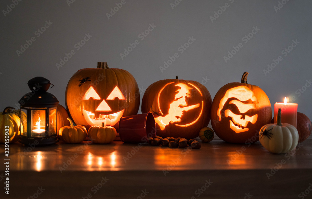 Fototapeta premium Halloween decorated pumpkins with candles and a lantern