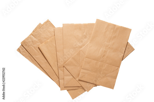 Brown paper bags with clipping path .
Pile of new kraft paper bags laying flat  isolated on white background .
 photo