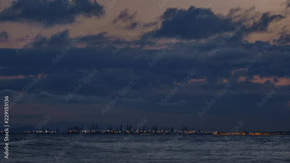 Sunset timelapse with cranes and port in Mediterranean sea Sunset timelapse with cranes and port in Mediterranean sea