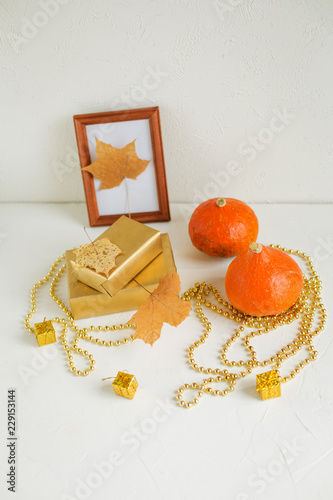 Still life on white. Pumpkins, autumn leaves photo