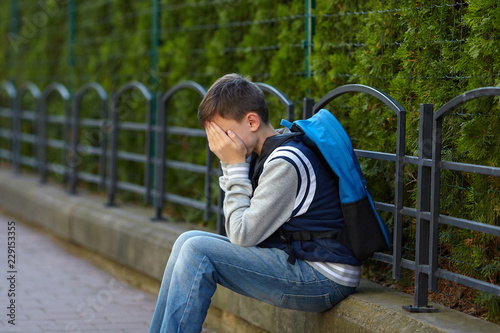 Schoolboy crying in the yard of the school © Roman Bodnarchuk