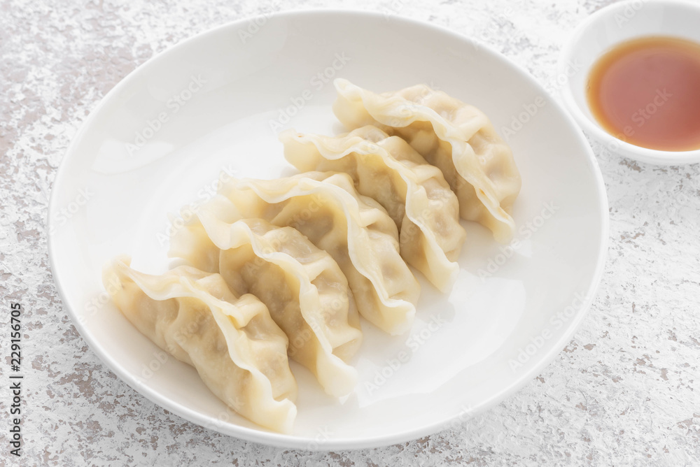 Japanese Gyoza with pork meat and on a plate
Japanese Gyoza with pork meat and on a plate