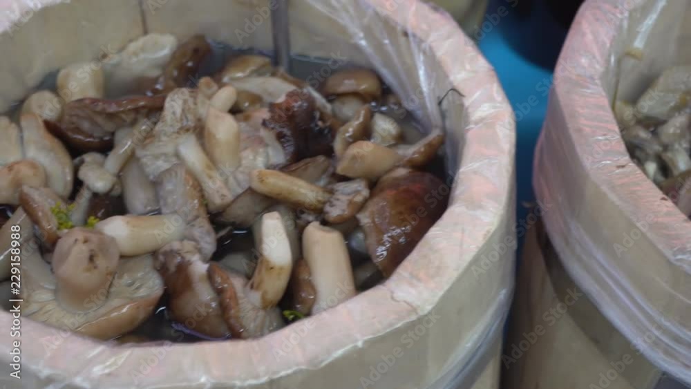 various salted and pickled mushrooms on the market counter