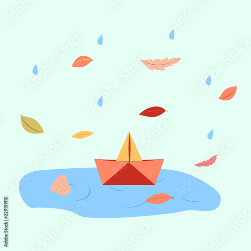 orange paper boat in a puddle of water