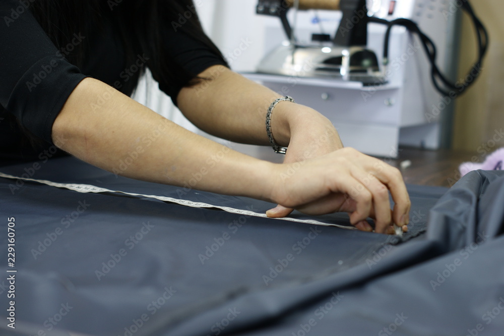Dressmaker cutter. Clothing designer. Process.