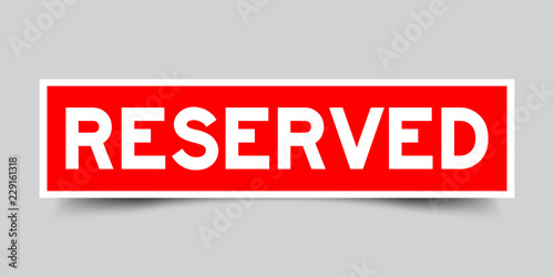Red color sticker in word reserved on gray background photo
