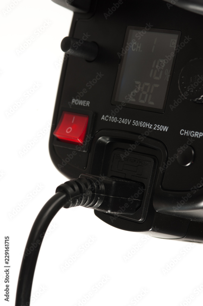 Close-up - side view - the back panel of a professional black studio illuminator with power button. Studio equipment concept Close-up - side view - the back panel of a professional black studio illuminator with power button. Studio equipment concept