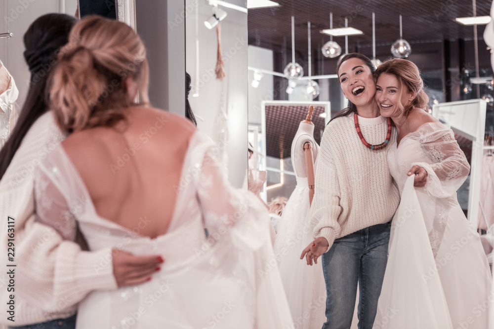 We are beautiful. Nice delighted women standing together while looking into the mirror We are beautiful. Nice delighted women standing together while looking into the mirror