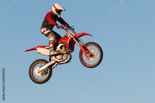 Freestyle motocross biker performs the jump at fmx competitions