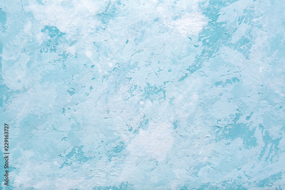 Fototapeta premium Light blue abstract background or decorative texture of old stucco wall. Textured damaged plaster. Art decor.