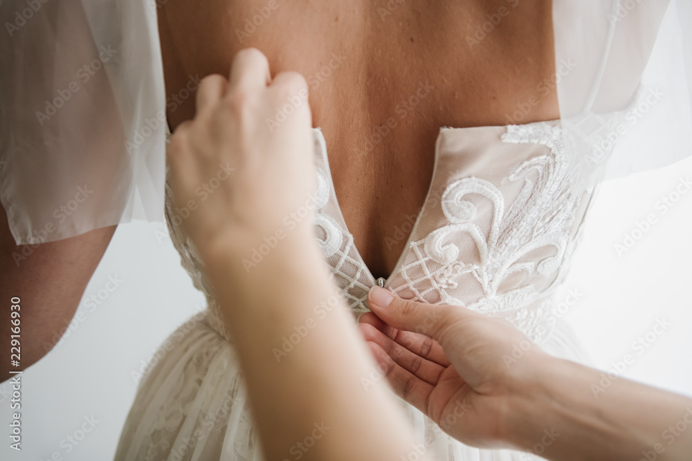 Hands helping to bride with dress Hands helping to bride with dress