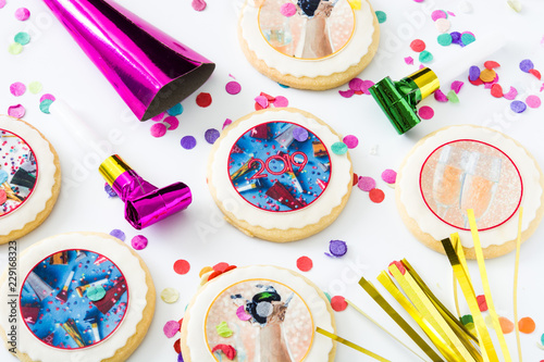 New Year cookies and confetti on white background