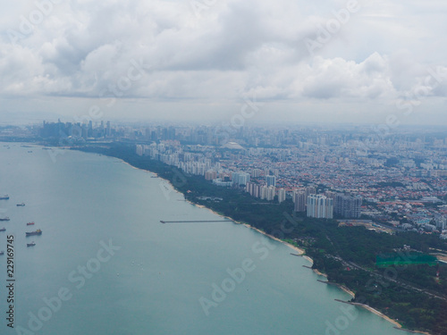 View from airplane window on fields in wing with top view of Singapore © metita