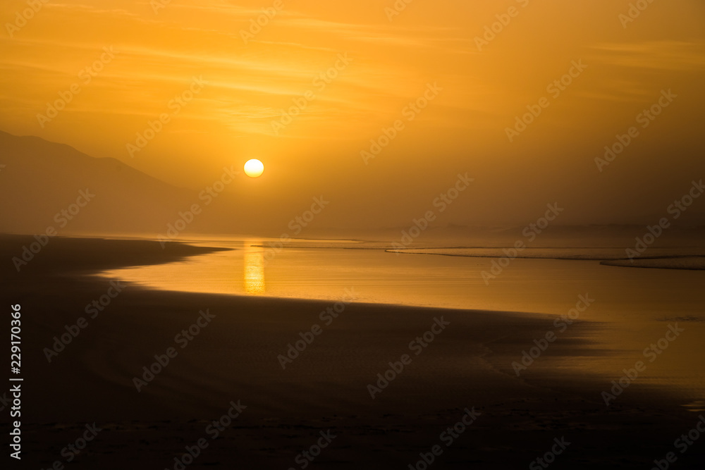 Silhouette of beach landscape during sunset in Cofete, Fuerteventura, Spain.