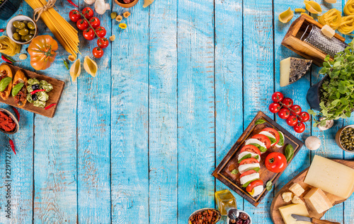 Various kind of italian food served on wood photo