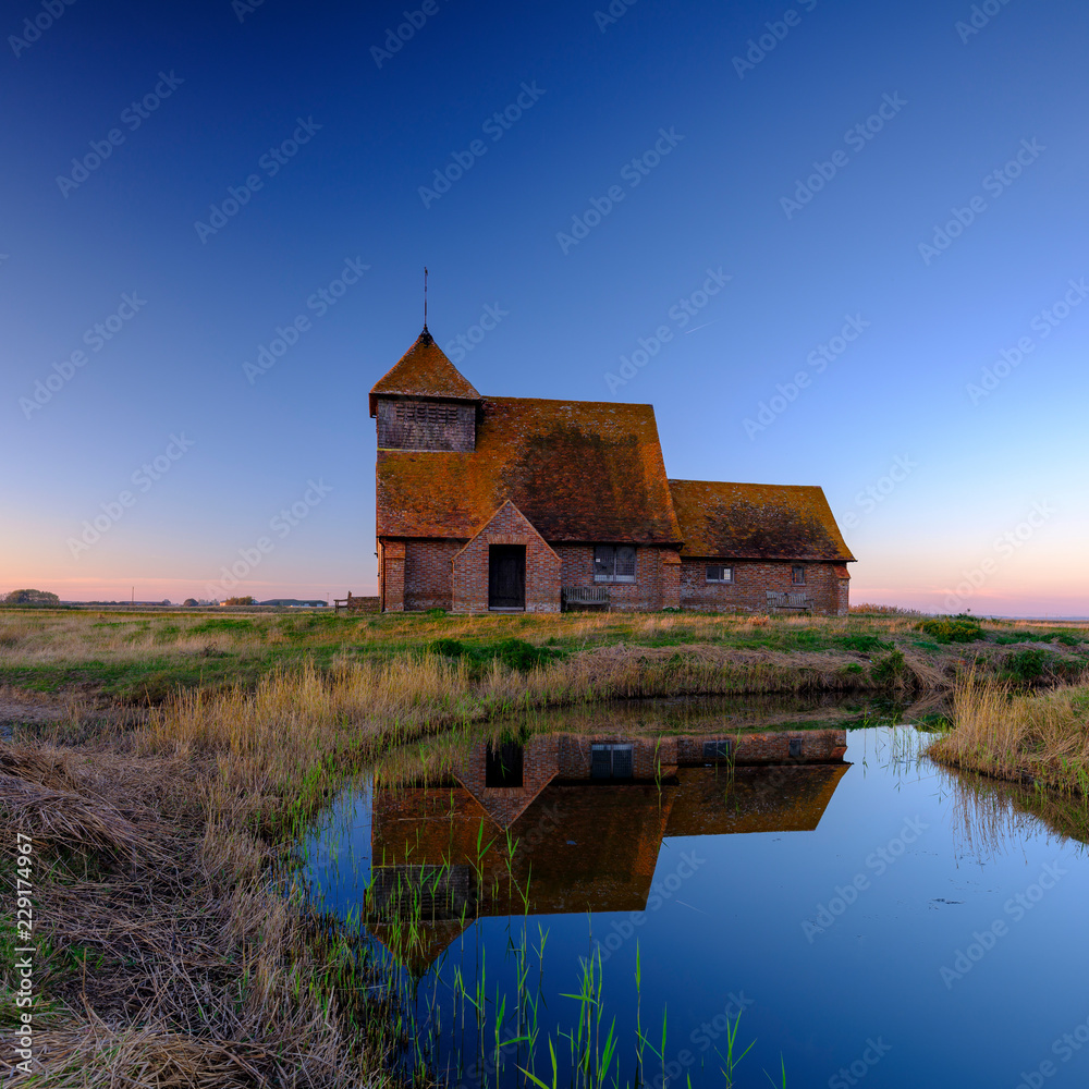 Autumnal clear evening sunset over St Thomas a Becket Church, Fairfield, in the Romney Marsh, Kent, UK Autumnal clear evening sunset over St Thomas a Becket Church, Fairfield, in the Romney Marsh, Kent, UK